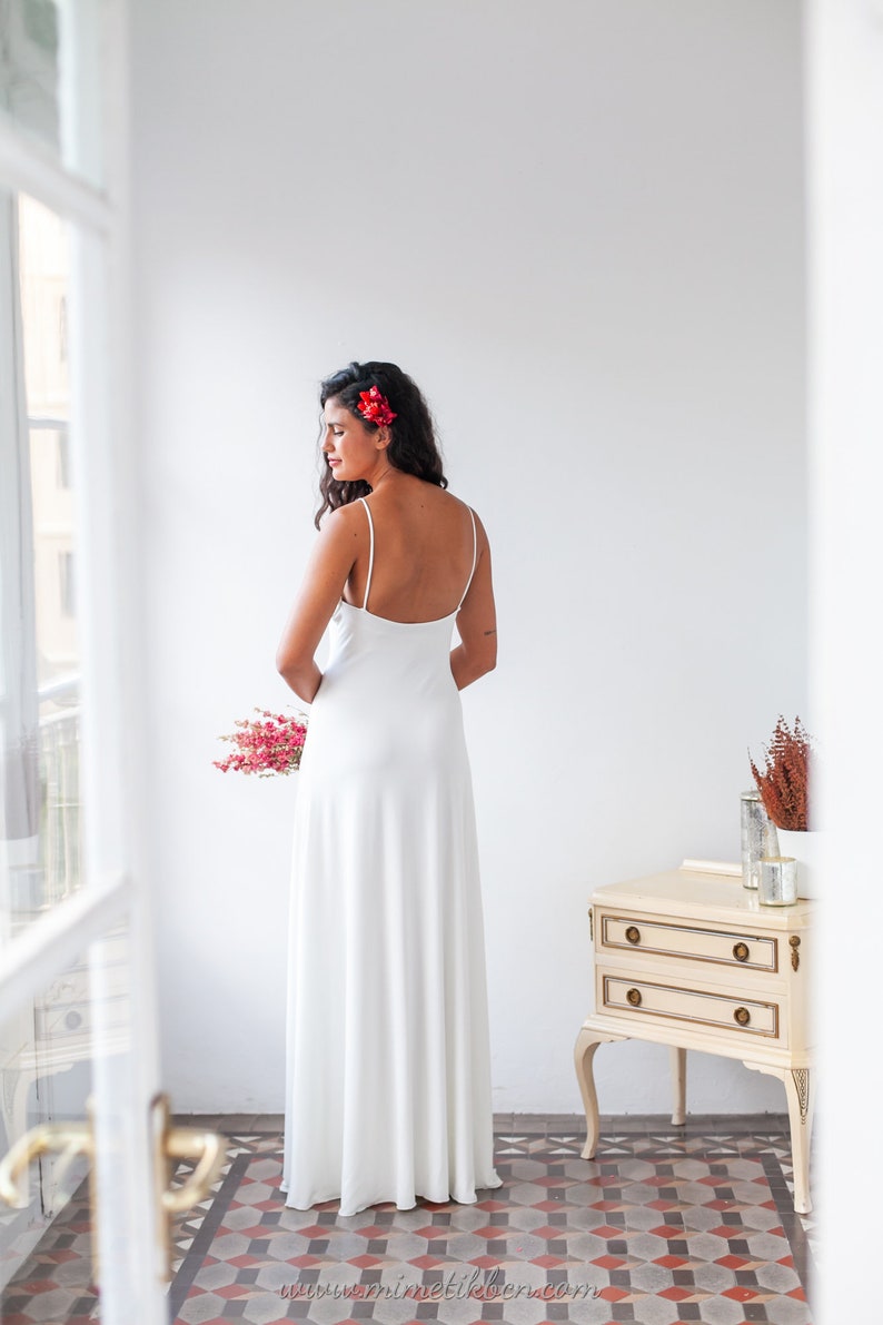 Simple and elegant slip wedding dress with thin spaghetti straps and low cut back image 4