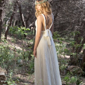 Beautiful bride in the nature wearing a convertible wedding dress. In this photo she is showing her back. Thanks to the multiway design, she can choose how much skin she shows or hides, adapting it to her body and style