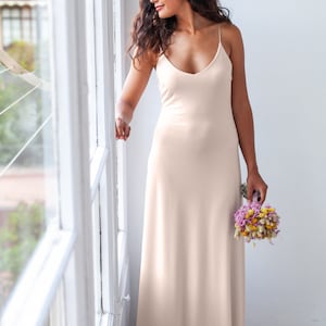 The woman is wearing the very same slip dress but this time in champagne satin jersey. Both colours, ivory and champagne, are very flattering both for brunettes and blondes.