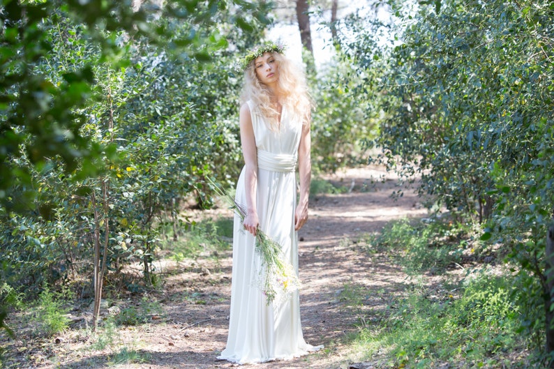 The model is wearing a long infinity dress as a wedding dress. It looks simple, but elegant and rustic.