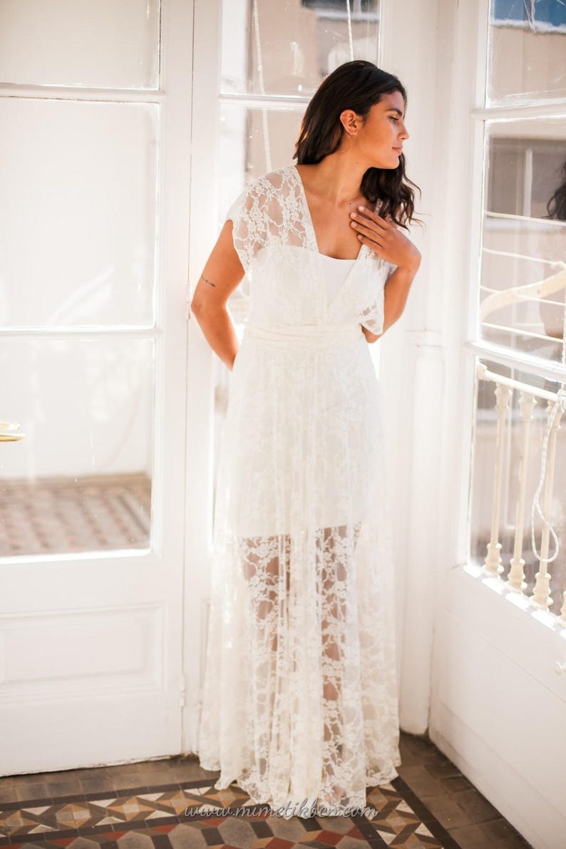 This time the woman is wearing the tube dress with an ivory lace overdress. She is looking outside, with an arm hidden on her back.