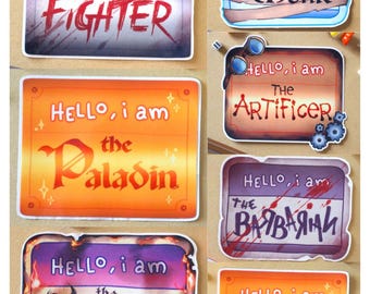 May include: A collection of seven rectangular stickers featuring the text HELLO, i am followed by character classes including THE FIGHTER, THE MONK, THE ARTIFICER, THE PALADIN, THE BARBARIAN, THE SORCERER, and THE ROGUE, each with unique color schemes.