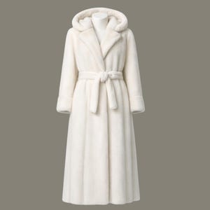 May include: A long, ivory-colored coat with a hood and a matching belt. The coat has a wrap-around design and is made of a soft, plush material. The coat is displayed on a mannequin against a neutral background.
