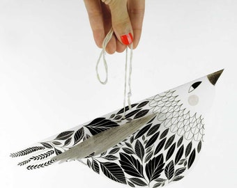 Illustrated cut out paper bird with black and white leaves, a beautiful paper sculpture for Christmas decor