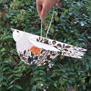 Illustrated hand cut paper bird with plants and floral motifs in green & orange, a beautiful paper sculpture for Valentine's day gift