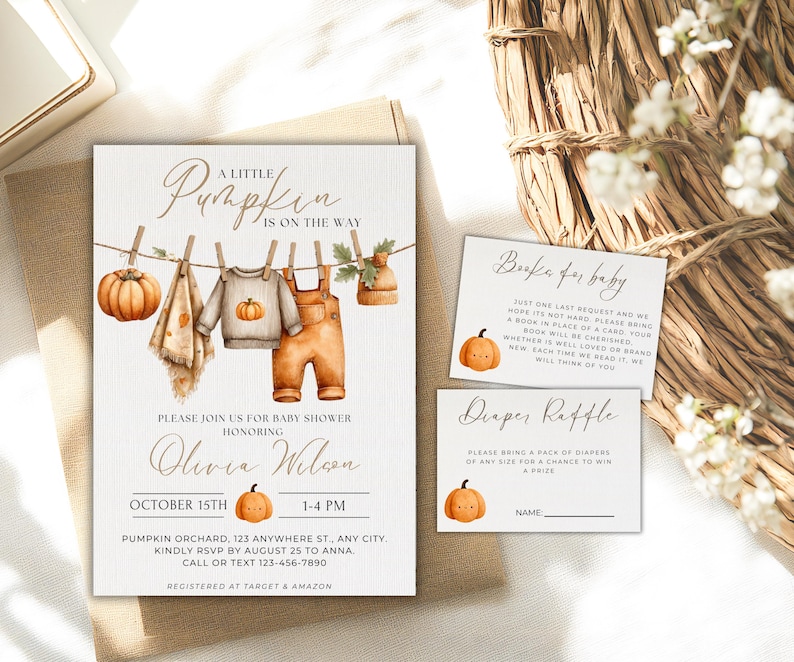 May include: Baby shower invitation set with a pumpkin theme. The invitation features watercolor illustrations of baby clothes, a pumpkin, and the text "A Little Pumpkin is on the Way." Includes inserts for books and diapers.