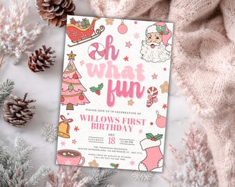 May include: A pink and white invitation card with Christmas-themed illustrations, including Santa Claus, a Christmas tree, and a sleigh. The text reads "Oh what fun" and announces a first birthday party.