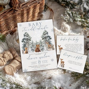 May include: A baby shower invitation and accompanying cards with a winter forest theme. The invitation reads "Baby, it's cold outside" and includes a bear, deer, and fox illustration. Additional cards request books and diapers.