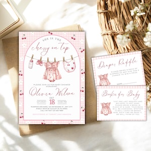 May include: Baby shower stationery set in pink with a cherry design. The invitation includes the phrase "She is the cherry on top" and event details. Inserts ask for diapers and books. The text is in English.