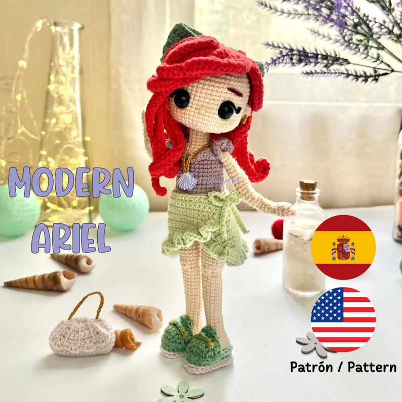 May include: A handmade crochet doll of Ariel, featuring red hair, a green skirt, and green sandals. The doll has a seashell necklace and is part of a collection. The text "Modern Ariel" is visible.