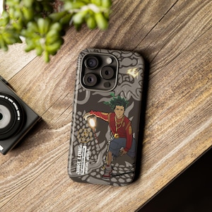 May include: A phone case with a cartoon illustration of a character in a red shirt and blue shorts, holding a glowing object. The case has a grey background with a dragon-like design and the text "JAKE LONG THE AMERICAN DRAGON SAFIA STELLA".