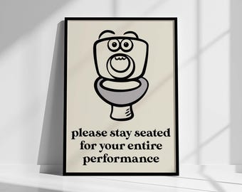 May include: A framed poster with a cartoon toilet illustration. The toilet is drawn with black outlines and gray shading, with a surprised expression. The text below reads "please stay seated for your entire performance."