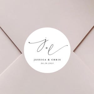 May include: White round sticker with a black script font monogram "J+L" and the text "Jessica & Chris 06.28.2025".
