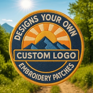 May include: Circular embroidered patch with a blue background and a gold border. The patch features a mountain and sun design in orange and blue, with the text "DESIGNS YOUR OWN" and "CUSTOM LOGO EMBROIDERY PATCHES" in white.