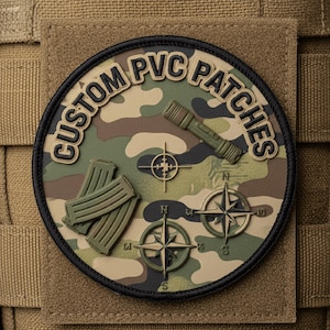 May include: A circular camouflage PVC patch with the text "CUSTOM PVC PATCHES". The patch features a flashlight, crosshairs, compasses, and ammunition magazines. The patch is attached to a tan fabric.