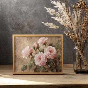 May include: A framed painting of pink roses with green leaves on a beige background. The painting is in a wooden frame.