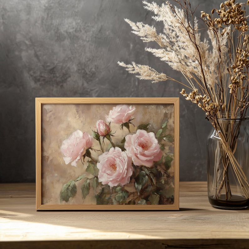 May include: A framed painting of pink roses with green leaves on a beige background. The painting is in a wooden frame.