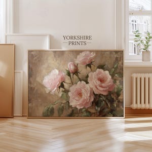 May include: A painting of a bouquet of pink roses with green leaves on a light brown background.