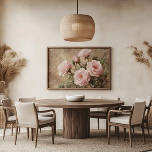 May include: A round wooden dining table with six chairs, a woven pendant light, and a painting of pink roses on the wall. The room is decorated in a minimalist style with beige walls and a woven rug.