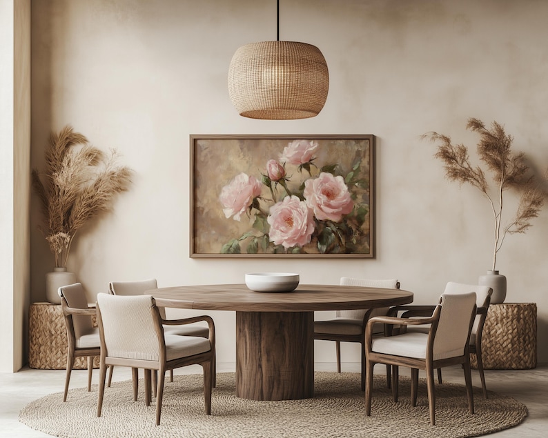 May include: A round wooden dining table with six chairs, a woven pendant light, and a painting of pink roses on the wall. The room is decorated in a minimalist style with beige walls and a woven rug.