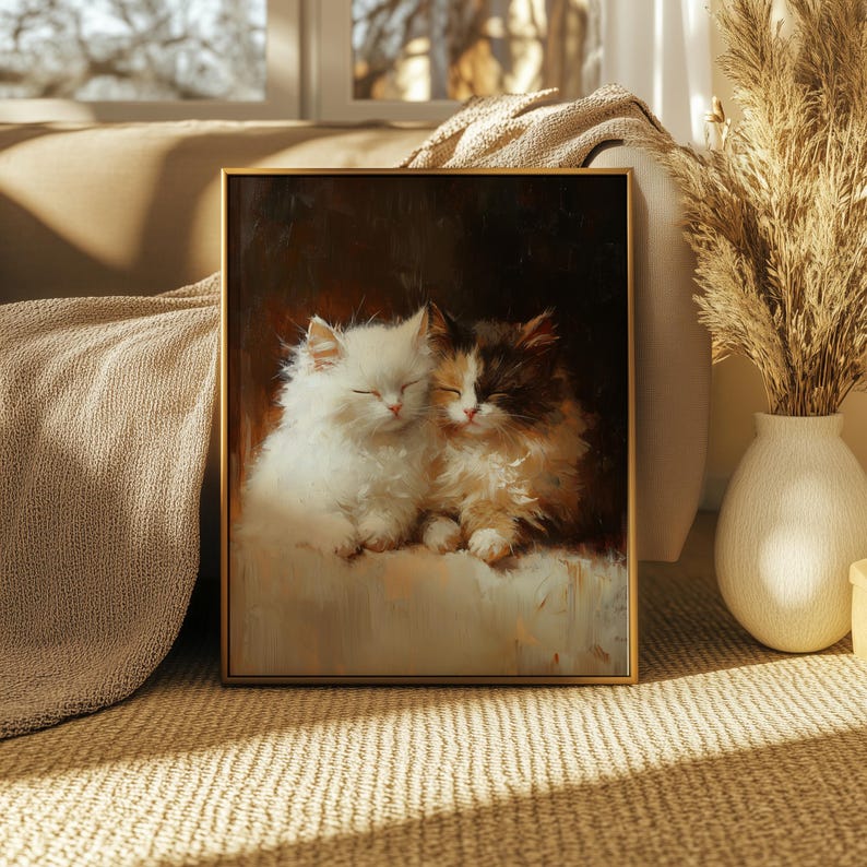 May include: A framed painting of two white and brown kittens sleeping together. The kittens are curled up on a white blanket. The painting has a dark brown background.