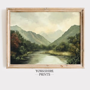 May include: A framed painting of a river flowing through a valley with mountains in the background. The sky is cloudy and the colors are muted greens and blues.