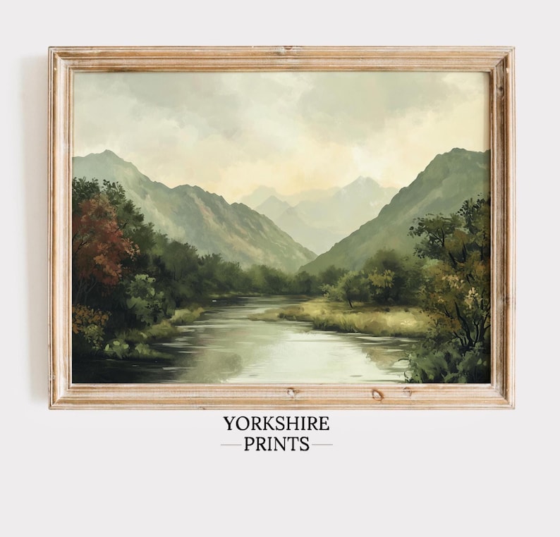 May include: A framed painting of a river flowing through a valley with mountains in the background. The sky is cloudy and the colors are muted greens and blues.