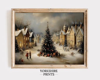 May include: A framed wall art print titled YORKSHIRE PRINTS depicting a snowy village scene at twilight. A large decorated Christmas tree stands in the centre of a snow-covered square surrounded by multi-storey houses with glowing windows and people.