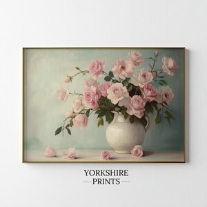 May include: A vintage-style painting of a bouquet of pink roses in a white vase against a light blue background.
