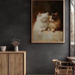 May include: A painting of two white and brown kittens cuddling together. The kittens are sleeping with their eyes closed. The painting is framed in a light brown frame.