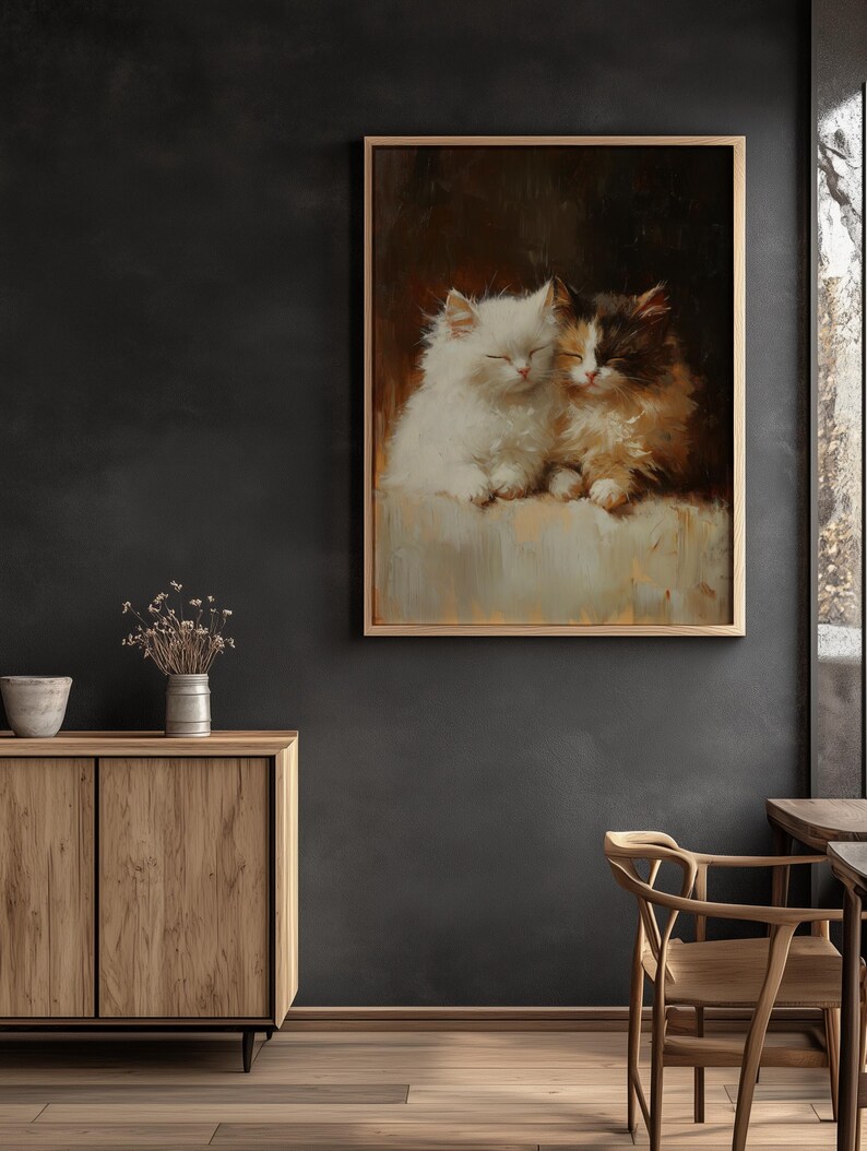 May include: A painting of two white and brown kittens cuddling together. The kittens are sleeping with their eyes closed. The painting is framed in a light brown frame.