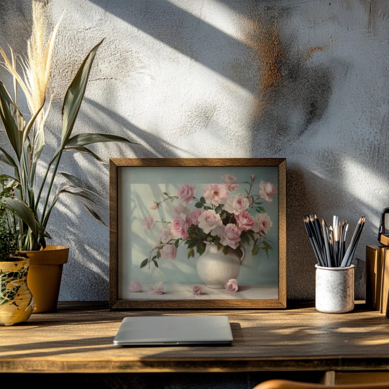 May include: A framed print of a still life featuring a bouquet of pink roses in a white vase. The roses are arranged in a vase on a light blue background. The print is framed in a brown wood frame.