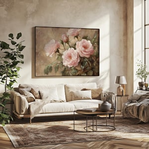 May include: A framed painting of a bouquet of pink roses with green leaves on a beige background. The painting is hanging on a wall above a white sofa in a living room.
