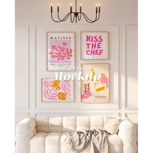 May include: A gallery wall arrangement of four framed art prints featuring abstract botanical shapes, the text Matisse, the text Kiss The Chef, and a graphic of a hand pouring coffee, displayed above a white tufted sofa with a throw blanket.