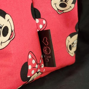 Red Minnie Mouse Tote bag close up of tag with heart skull and lipstick