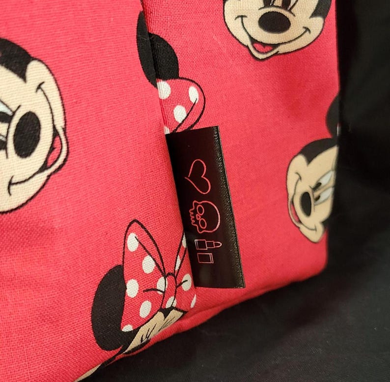 Red Minnie Mouse Tote bag close up of tag with heart skull and lipstick