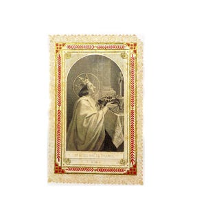 May include: A vintage religious card with a gold border and a picture of a man in a crown holding a wreath. The text on the card reads "St Louis Roi de France 91.108".