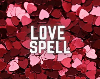 May include: A close-up image of red heart-shaped confetti with the text "LOVE SPELL" in white letters.