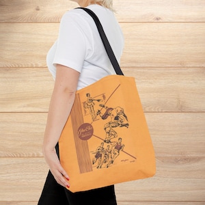 May include: Orange tote bag featuring vintage sports illustrations in brown and white. The bag has a black strap and a circular logo with text. The illustrations depict various sports figures in action.