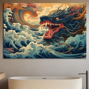 May include: A large canvas print depicting a Japanese-style dragon emerging from ocean waves. The dragon is dark blue with a red mouth and white teeth. The waves are blue and white, with a yellow and orange sky in the background. The artwork is displayed in a bathroom.