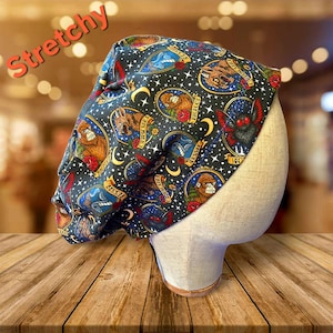 May include: A set of three ceramic mugs with a speckled, cream-colored glaze. Each mug features a different hand-painted design: a blue and green leaf, a yellow flower, and a red berry. The mugs have a simple, rounded shape.