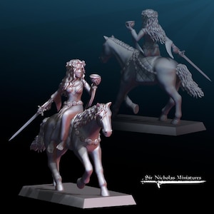 May include: A detailed miniature sculpture of a woman riding a horse, holding a cup and a sword. The woman wears a floral crown and flowing gown. The horse is adorned with decorative elements. The sculpture is on a rectangular base.