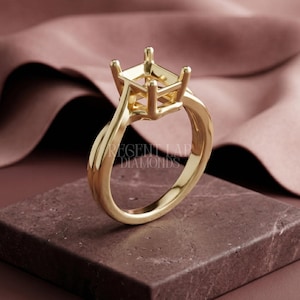 May include: A gold ring setting with a four-prong head, designed to hold a square-cut gemstone. The band has a twisted design. The ring is displayed on a dark brown surface with the text "REGENT LAB DIAMONDS".