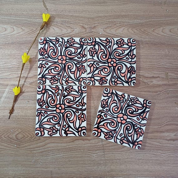 Authentic hand-painted Moroccan zellige tiles with coral arabesque patterns — the kind of artisan tile work that transforms a backsplash into a story.