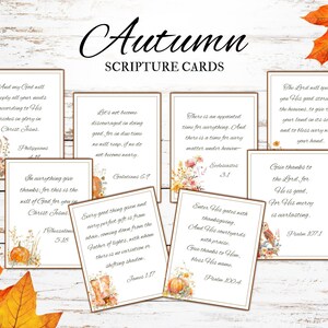 May include: A set of autumn-themed scripture cards. Each card displays a different Bible verse, decorated with floral and pumpkin motifs. The cards are arranged on a light wood background with autumnal leaves.