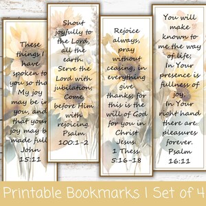 May include: A set of four rectangular bookmarks featuring watercolor sunflower illustrations and printed Bible verses. Each bookmark displays distinct religious text including John 15:11, Psalm 100:1-2, 1 Thessalonians 5:16-18, and Psalm 16:11 in a clear black serif font.