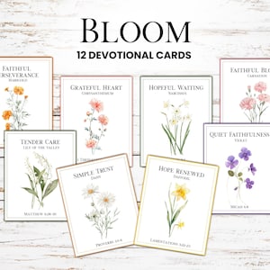 May include: A collection of 12 devotional cards with floral illustrations. Each card features a different flower, such as marigold, daffodil, and violet, along with inspirational text. The word "BLOOM" is at the top.