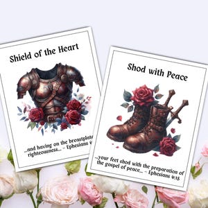 May include: Two art prints with floral and armor themes. One features a breastplate with red roses and the text "Shield of the Heart." The other shows boots, swords, and roses, with the text "Shod with Peace."