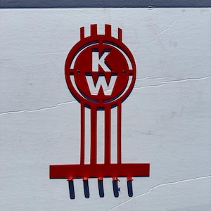 May include: Red metal wall hook with a KW logo and five hooks.