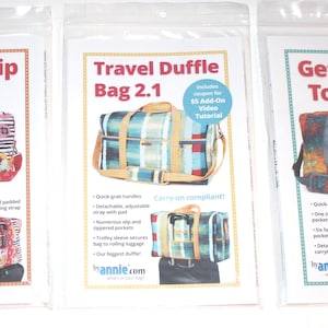 May include: Three sewing patterns in clear plastic sleeves titled Round Trip Duffle, Travel Duffle Bag 2.1, and Get Out of Town 2.1. Each pattern features a color photograph of a finished duffle bag with various fabric prints and designs.